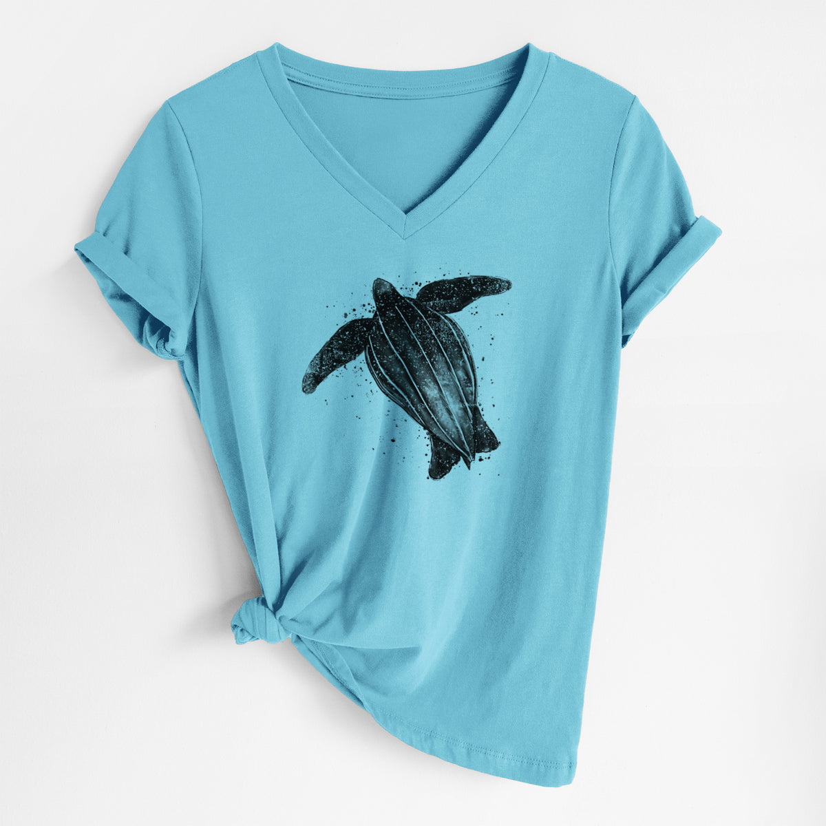Turquoise women's relaxed fit cotton V-neck t-shirt laid flat, printed with a black ink illustration of a leatherback sea turtle swimming, with ink splatters.