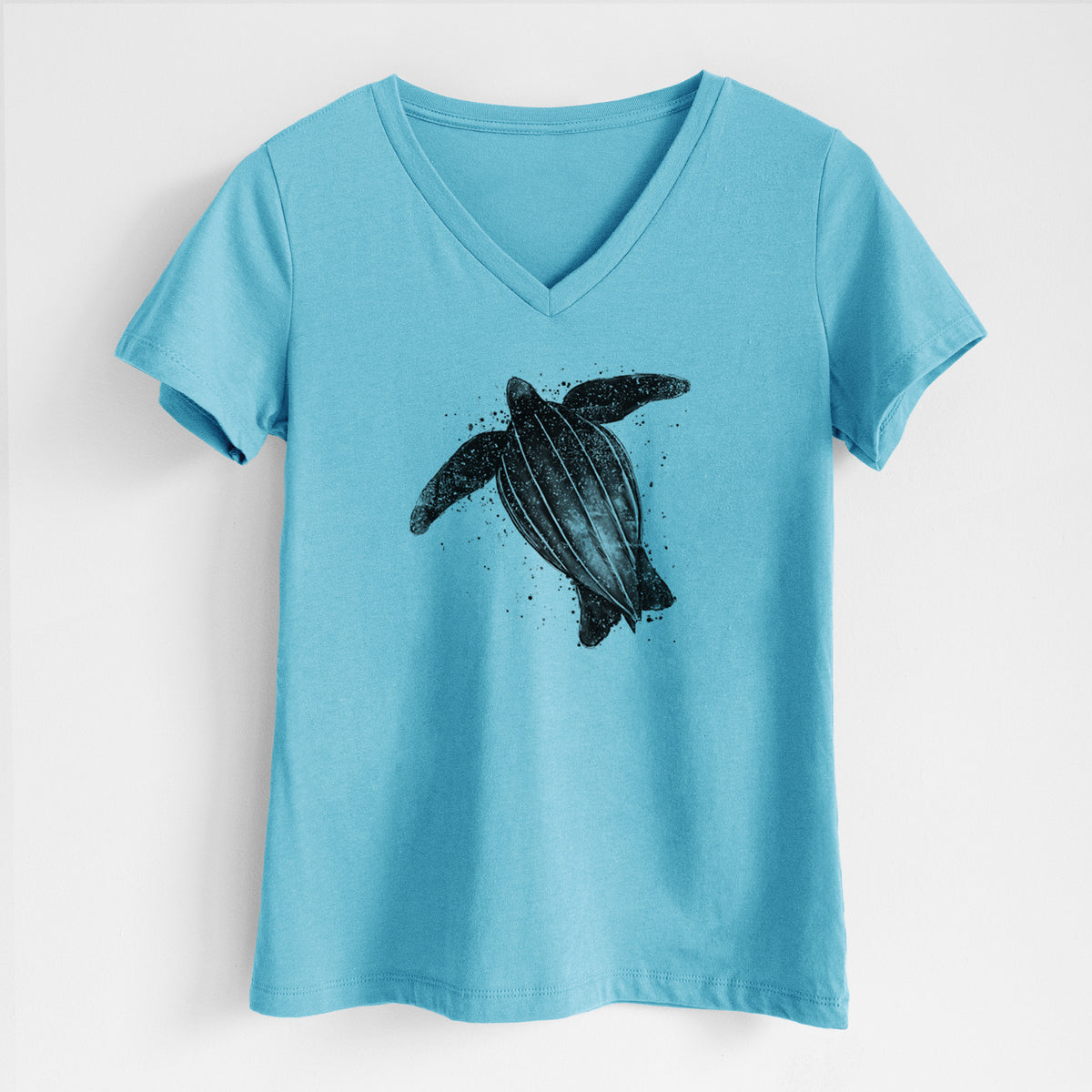 Turquoise women's relaxed fit cotton V-neck t-shirt laid flat, printed with a black ink illustration of a leatherback sea turtle swimming, with ink splatters.