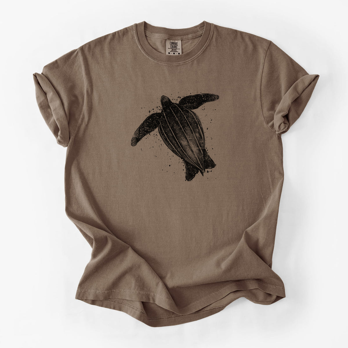 Espresso brown Comfort Colors t-shirt laid flat, printed with a black ink illustration of a leatherback sea turtle swimming, with ink splatters.