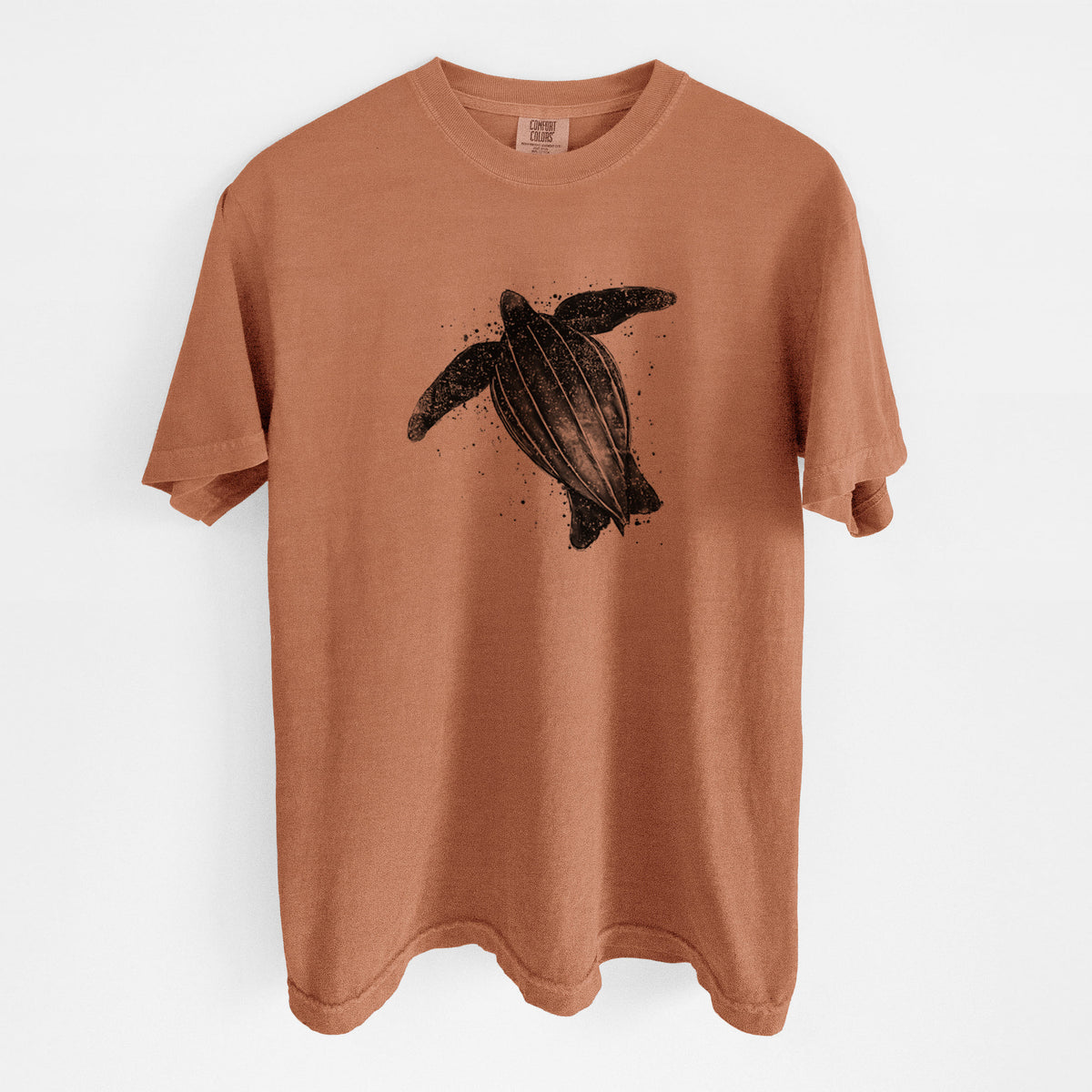 Yam burnt orange Comfort Colors t-shirt laid flat, printed with a black ink illustration of a leatherback sea turtle swimming, with ink splatters.