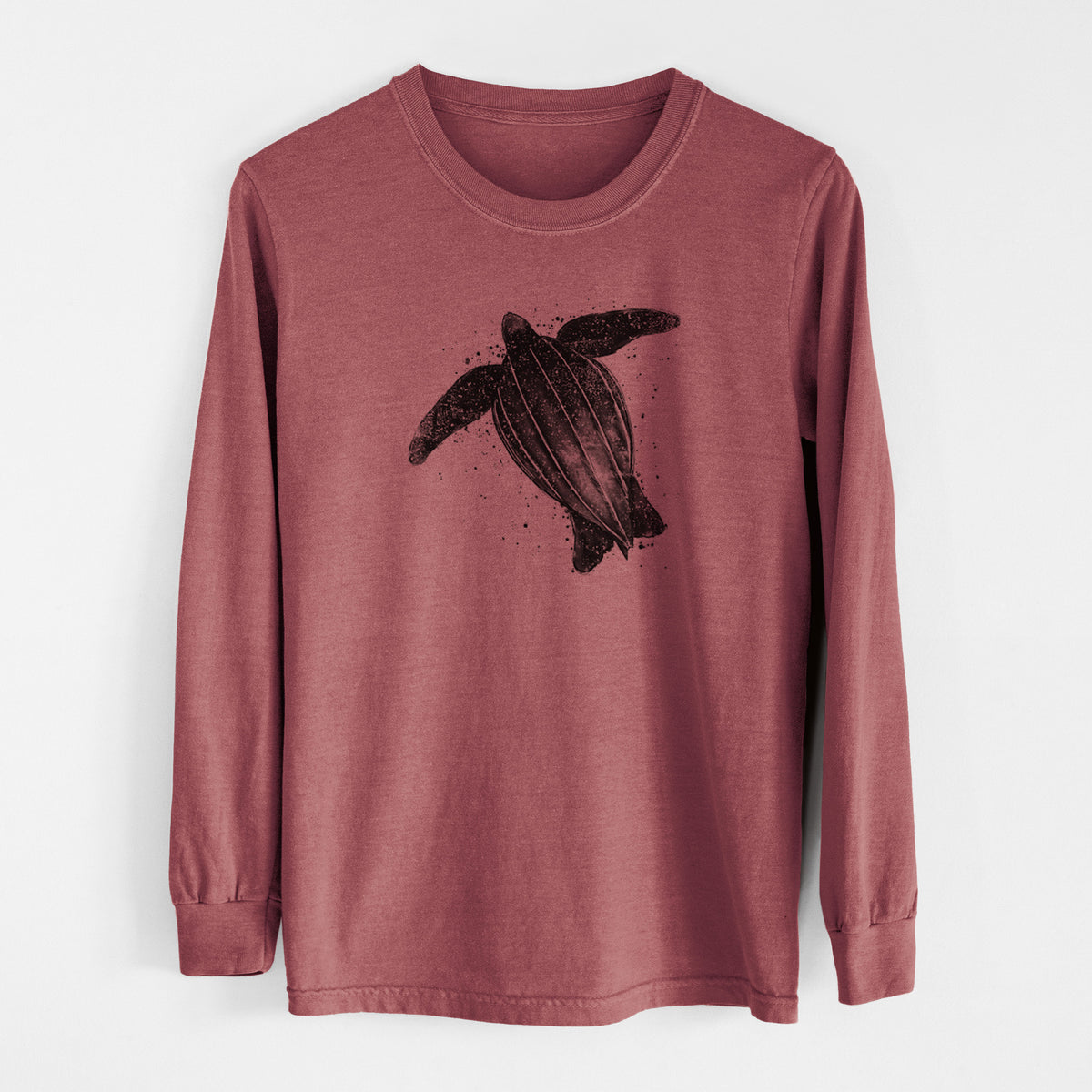 Brick red Comfort Colors long sleeve shirt laid flat, printed with a black ink illustration of a leatherback sea turtle swimming, with ink splatters.