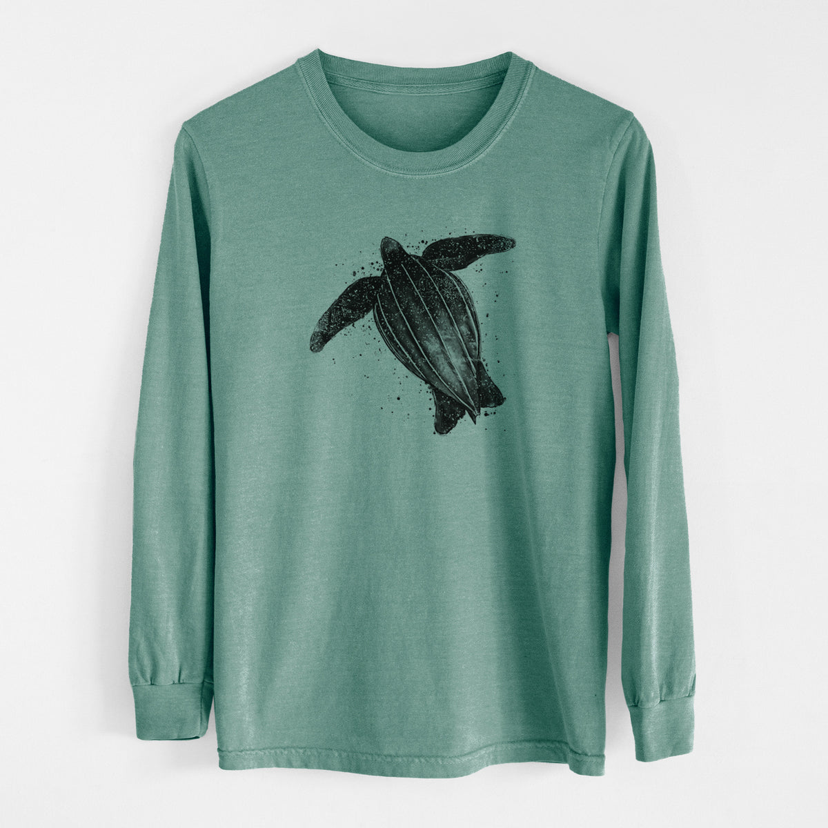 Pine green Comfort Colors long sleeve shirt laid flat, printed with a black ink illustration of a leatherback sea turtle swimming, with ink splatters.