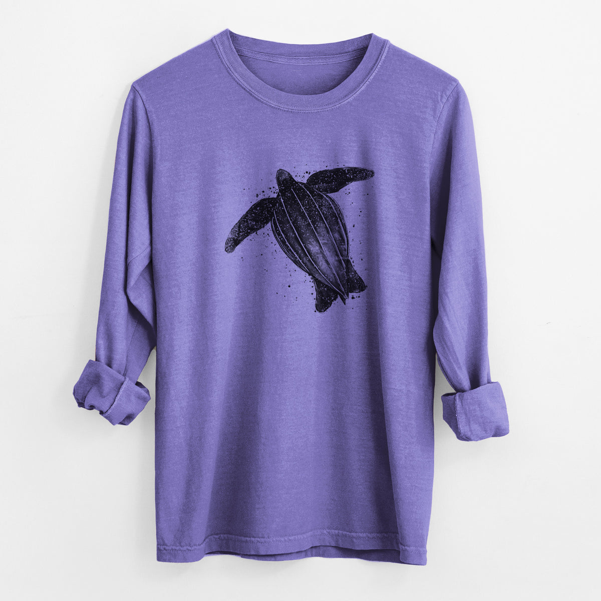 Violet purple Comfort Colors long sleeve shirt laid flat with the cuffs rolled, printed with a black ink illustration of a leatherback sea turtle swimming, with ink splatters.