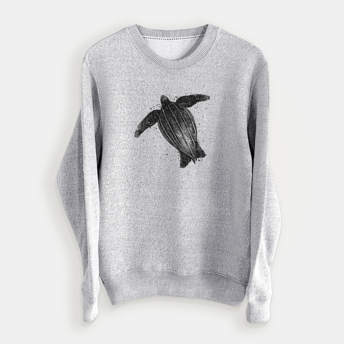 Salt and pepper knit sweatshirt laid flat, printed with a black ink illustration of a leatherback sea turtle swimming, with ink splatters.