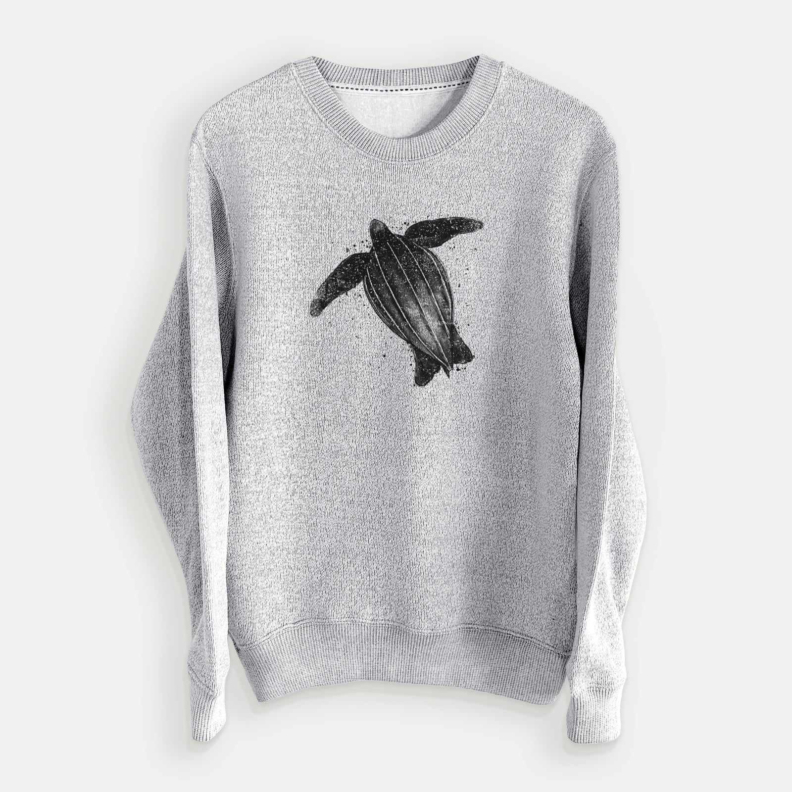 Salt and pepper knit sweatshirt laid flat, printed with a black ink illustration of a leatherback sea turtle swimming, with ink splatters.