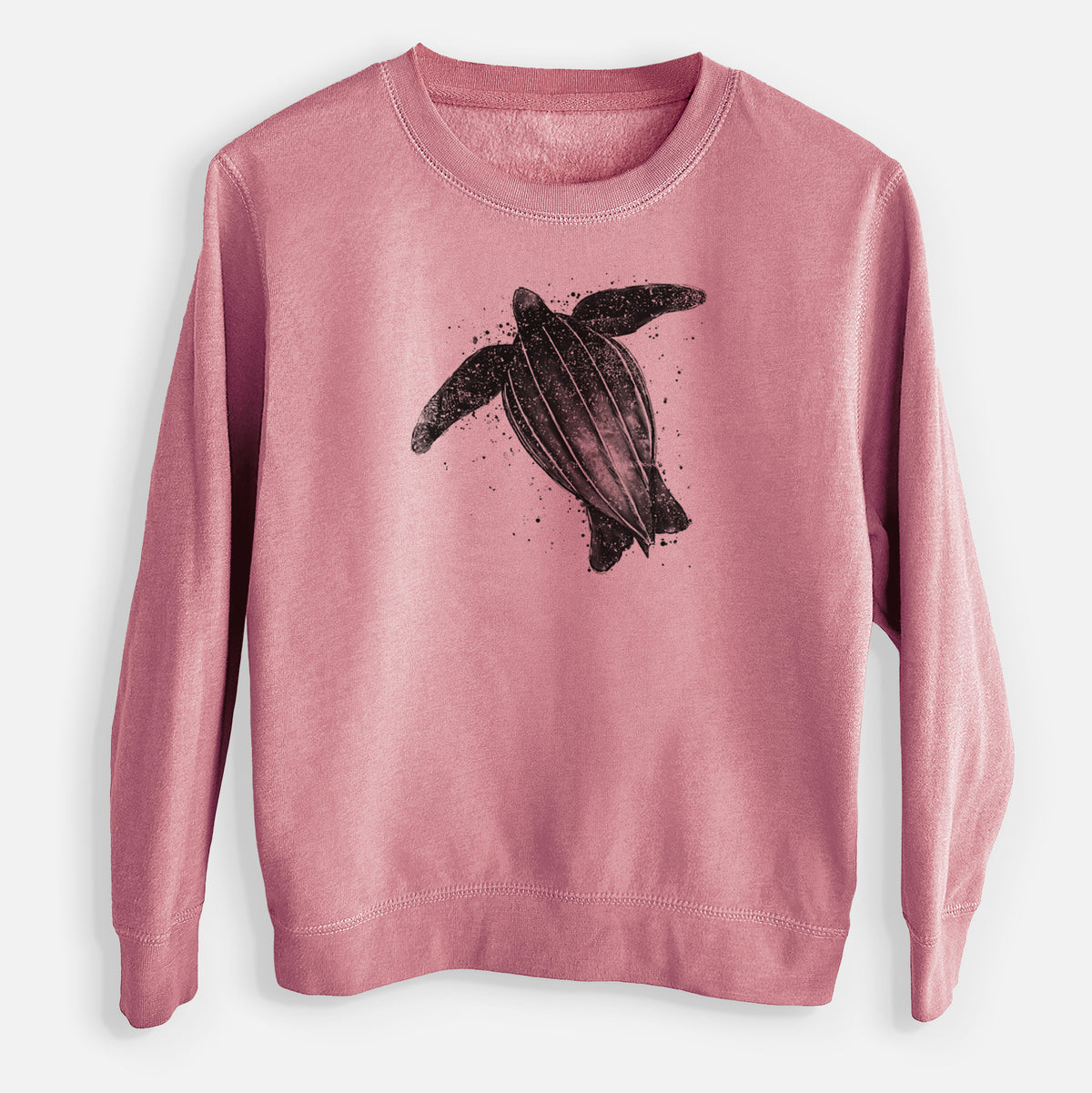 Mauve pink youth crewneck sweatshirt laid flat, printed with a black ink illustration of a leatherback sea turtle swimming, with ink splatters.