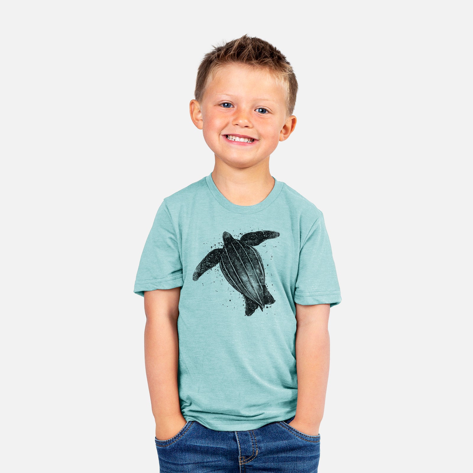 Two youth t-shirts in different colors on hangers, printed with a black ink illustration of a leatherback sea turtle swimming, with ink splatters.
