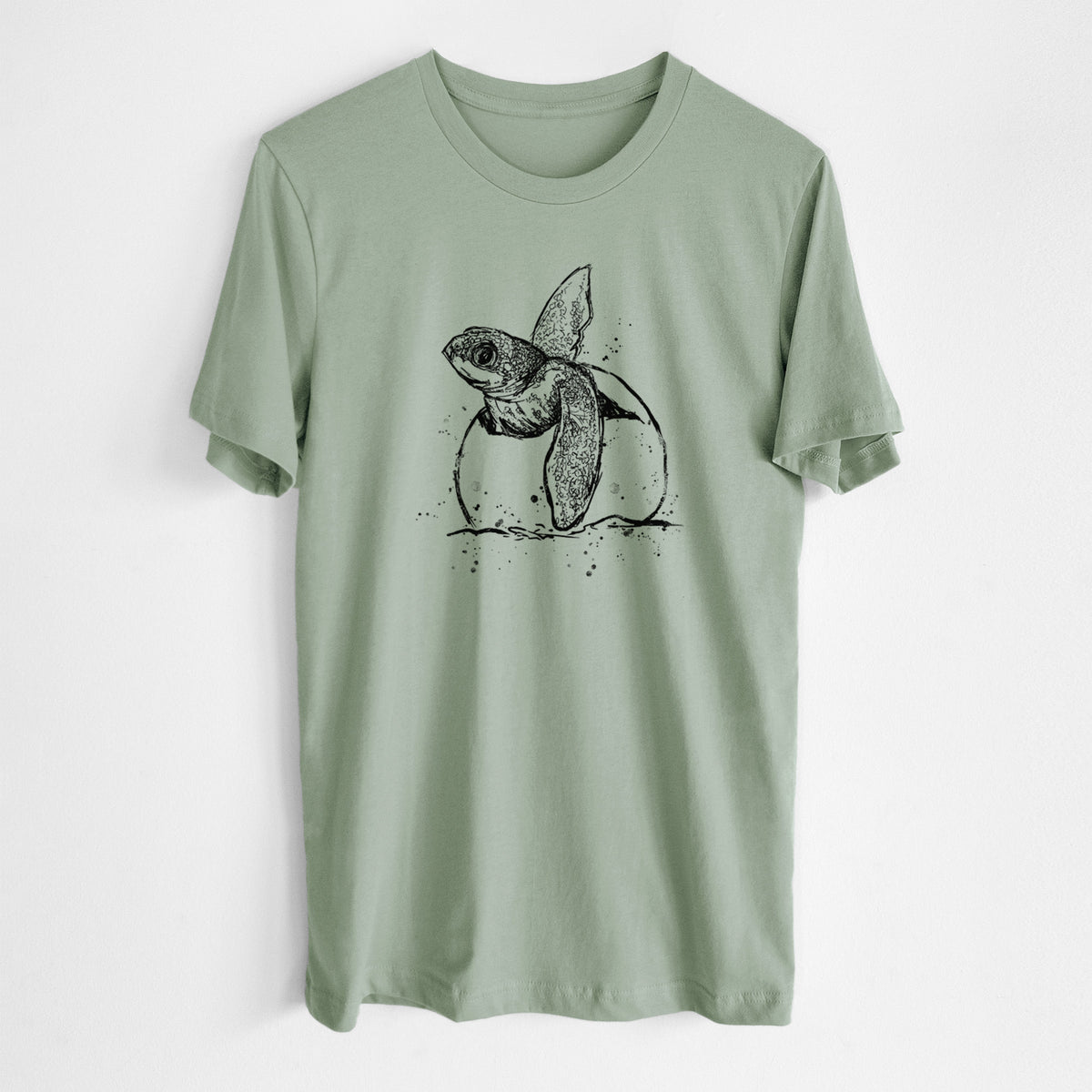 Sage green lightweight cotton t-shirt laid flat, printed with a black ink illustration of a leatherback sea turtle hatchling emerging from its egg.