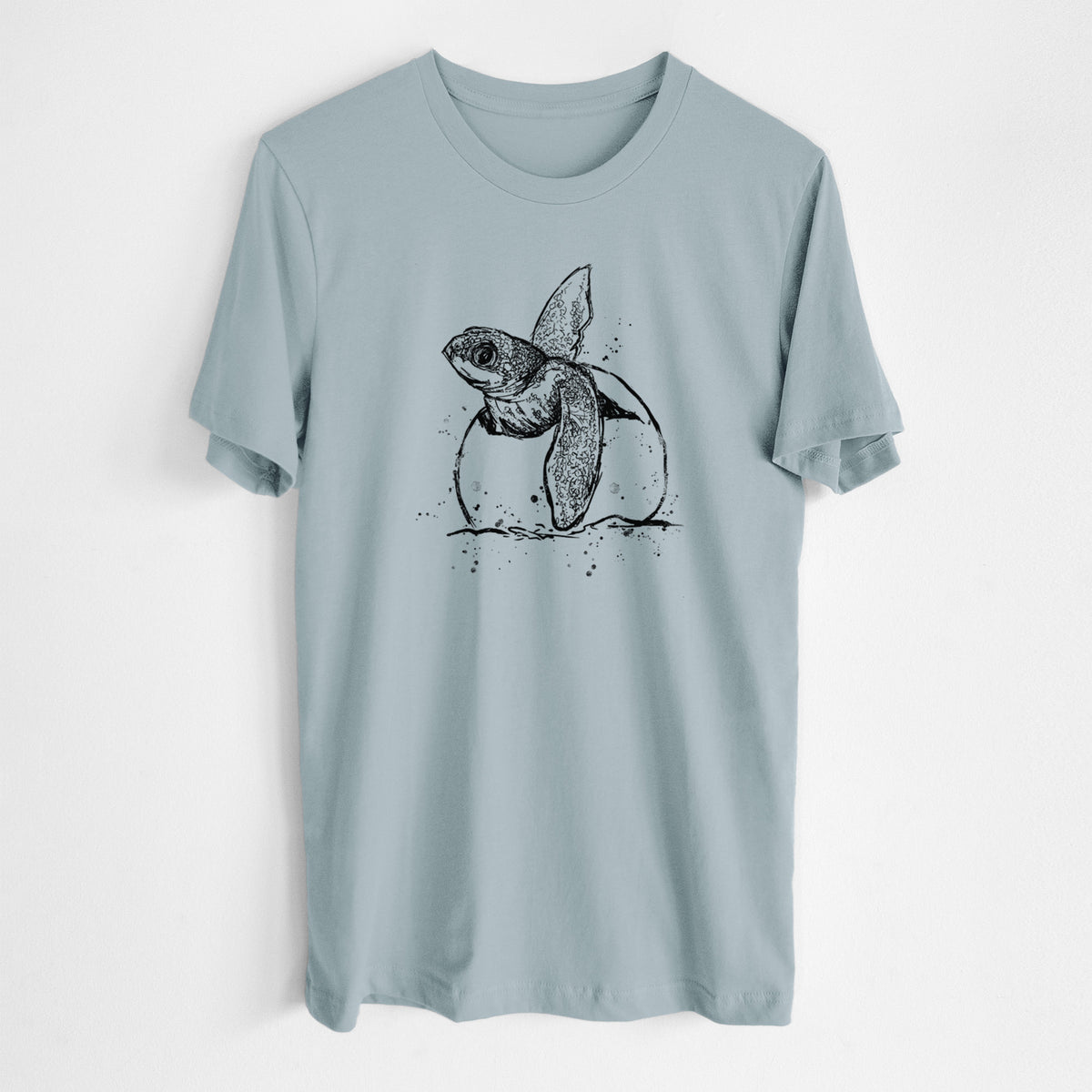 Vintage denim lightweight cotton t-shirt laid flat, printed with a black ink illustration of a leatherback sea turtle hatchling emerging from its egg.