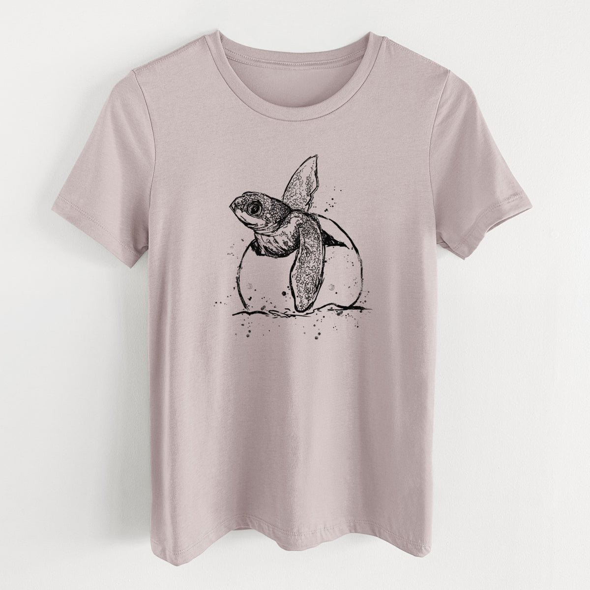 Pink gravel women's relaxed fit cotton t-shirt laid flat, printed with a black ink illustration of a leatherback sea turtle hatchling emerging from its egg.