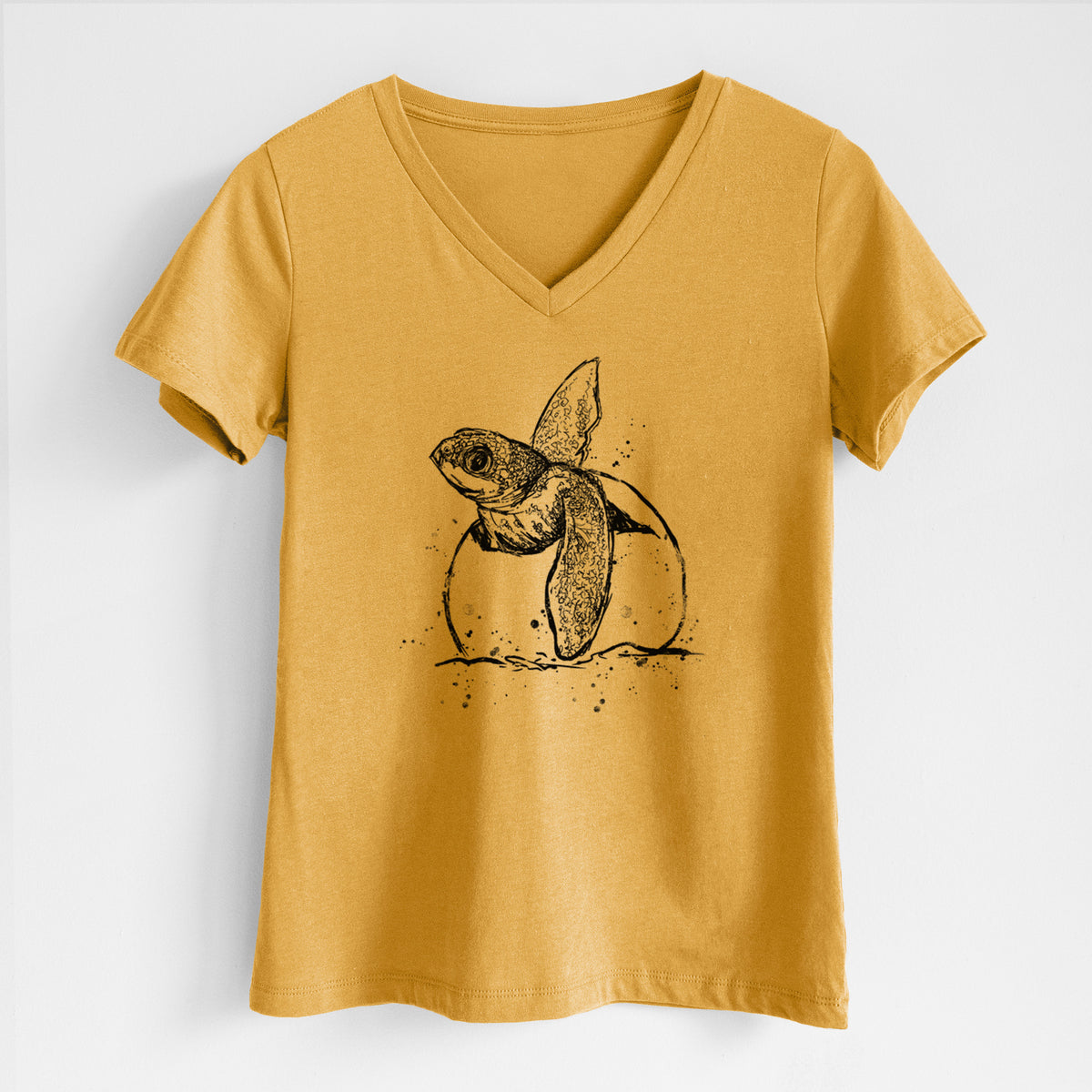 Honeycomb yellow women's relaxed fit cotton V-neck t-shirt laid flat, printed with a black ink illustration of a leatherback sea turtle hatchling emerging from its egg.