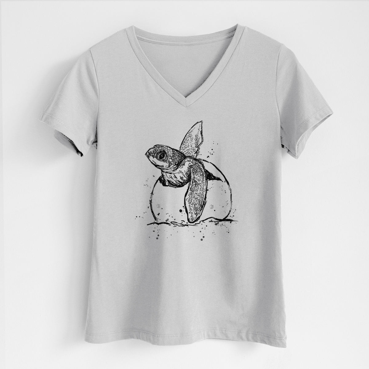 Lunar grey women's relaxed fit cotton V-neck t-shirt laid flat, printed with a black ink illustration of a leatherback sea turtle hatchling emerging from its egg.