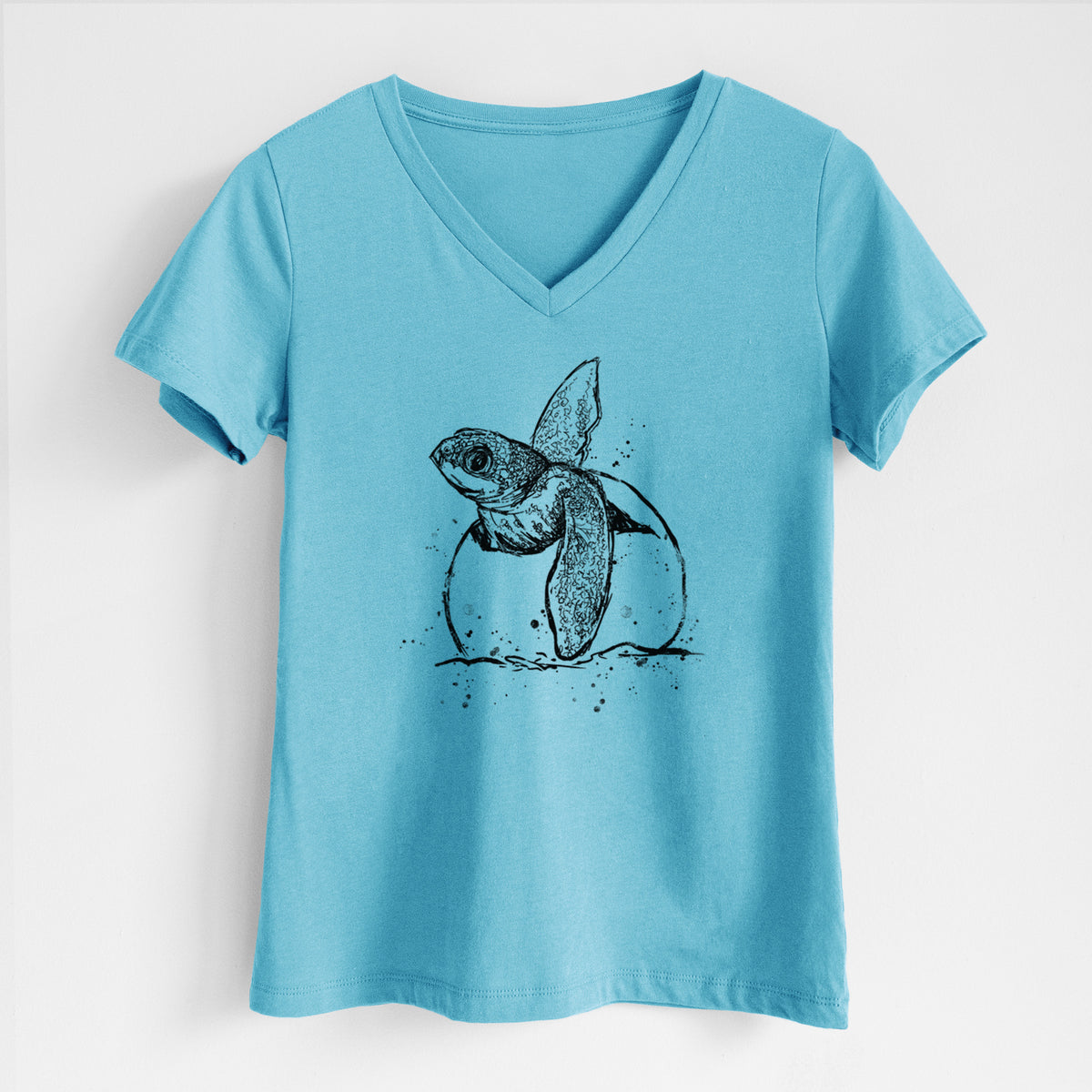 Turquoise women's relaxed fit cotton V-neck t-shirt laid flat, printed with a black ink illustration of a leatherback sea turtle hatchling emerging from its egg.