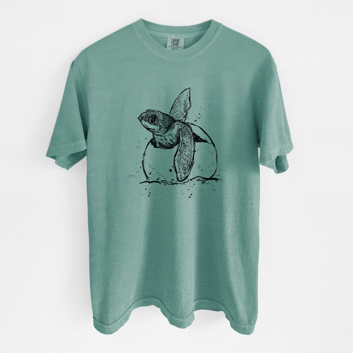 Reef green Comfort Colors t-shirt laid flat, printed with a black ink illustration of a leatherback sea turtle hatchling emerging from its egg.