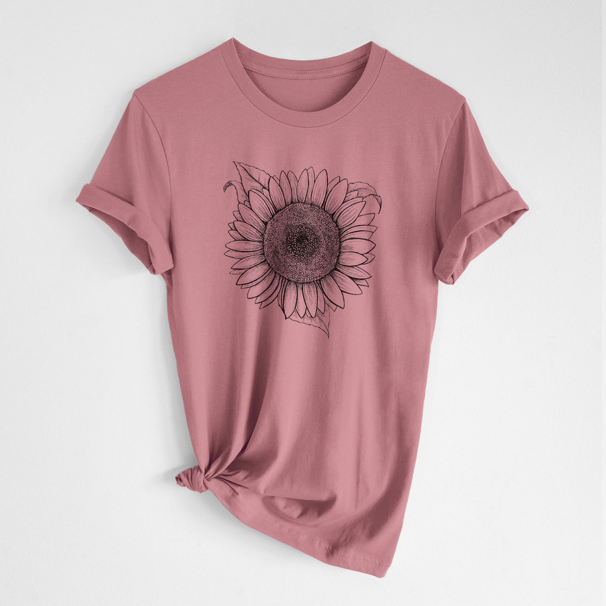 Mauve pink lightweight cotton t-shirt laid flat with the sleeves rolled, printed with a detailed black ink line drawing of a Lemon Queen sunflower in bloom.