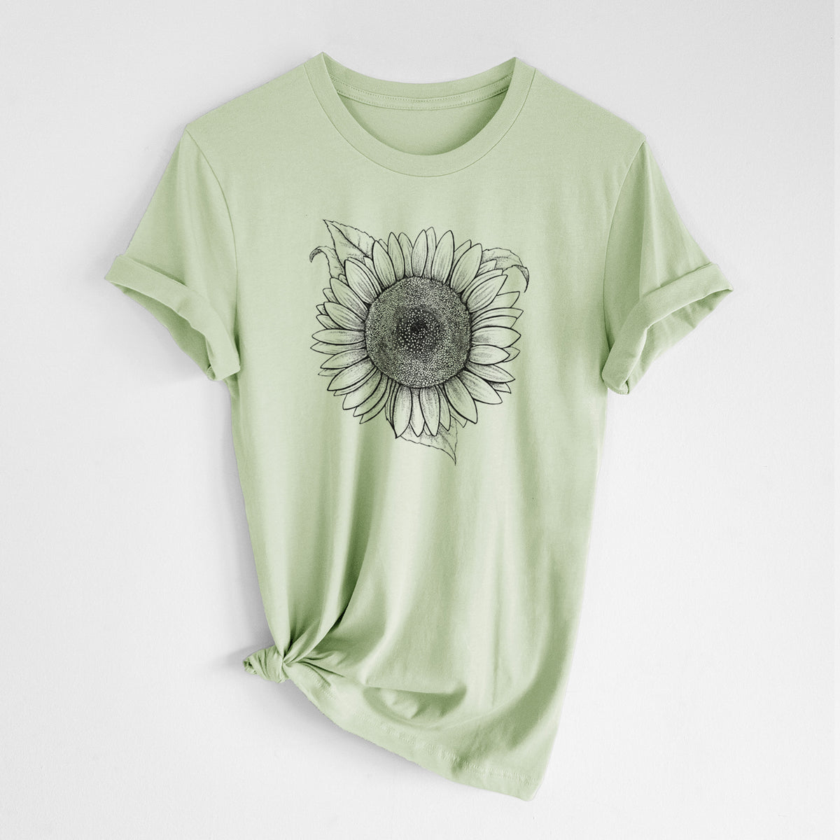 Spring green lightweight cotton t-shirt laid flat with the sleeves rolled, printed with a detailed black ink line drawing of a Lemon Queen sunflower in bloom.