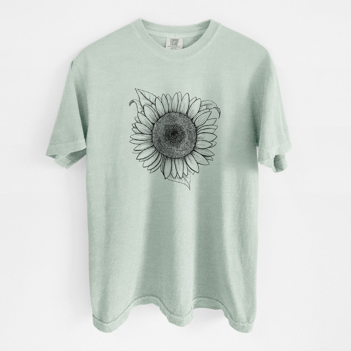 Bay green Comfort Colors t-shirt laid flat, printed with a detailed black ink line drawing of a Lemon Queen sunflower in bloom.