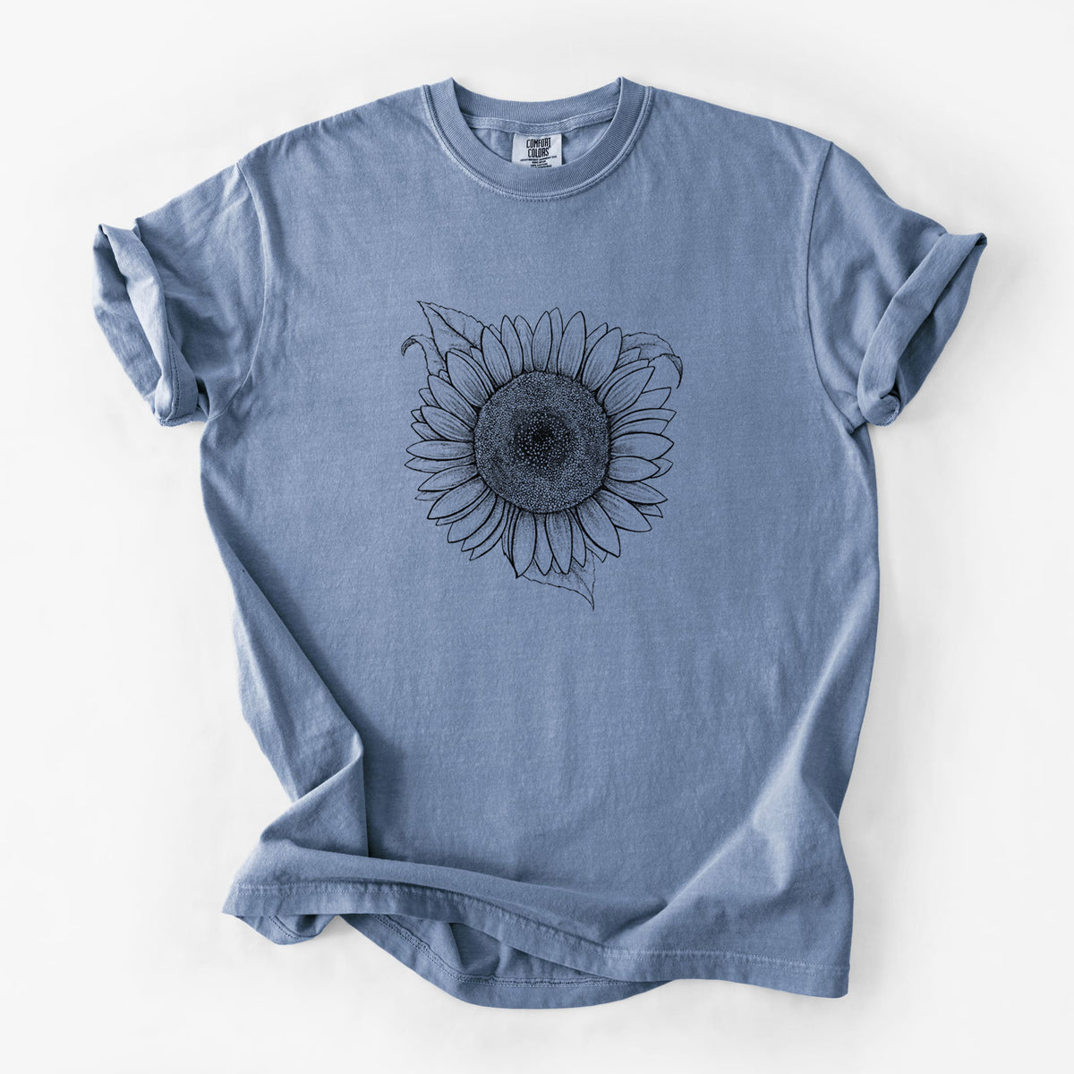 Blue jean Comfort Colors t-shirt laid flat, printed with a detailed black ink line drawing of a Lemon Queen sunflower in bloom.