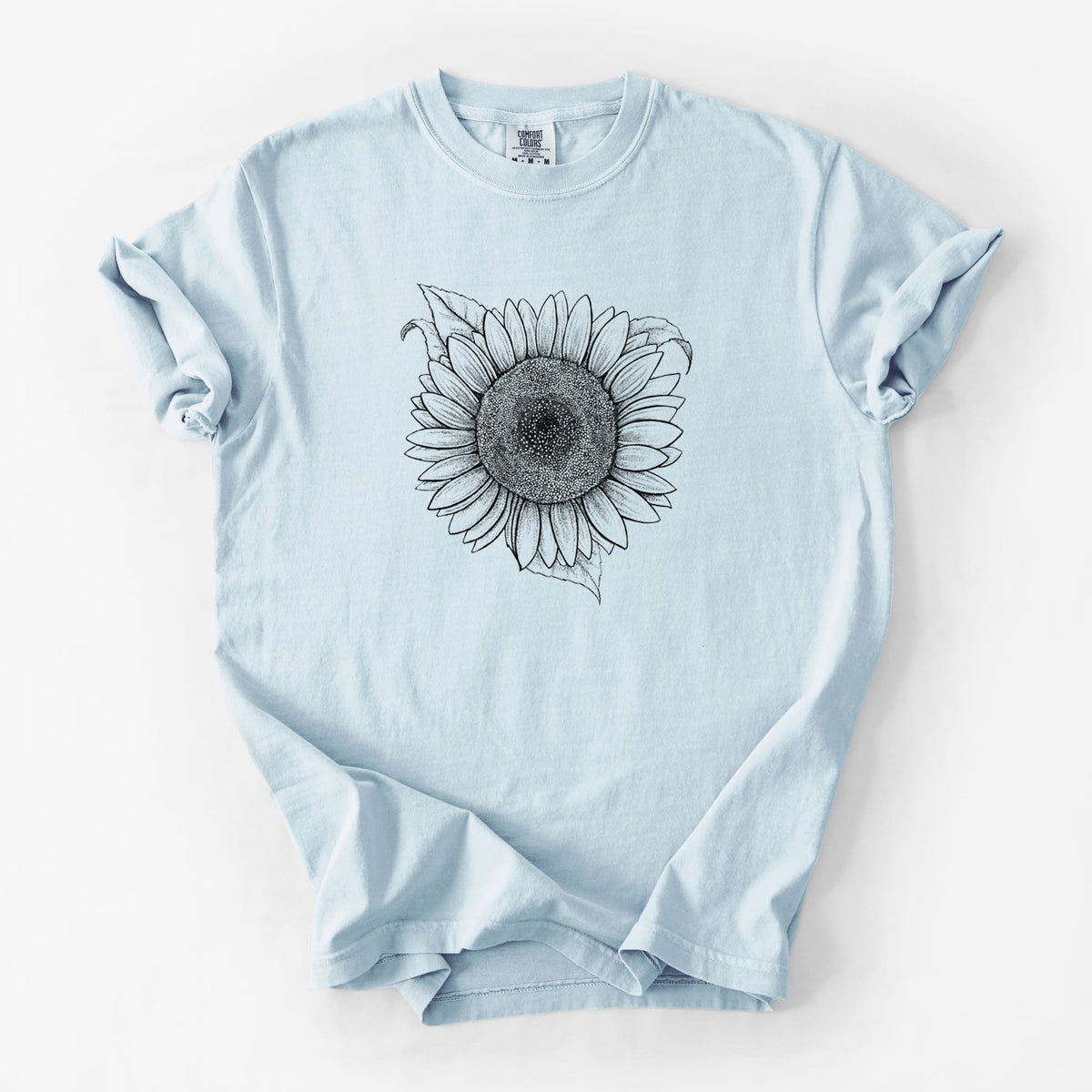 Chambray blue Comfort Colors t-shirt laid flat, printed with a detailed black ink line drawing of a Lemon Queen sunflower in bloom.