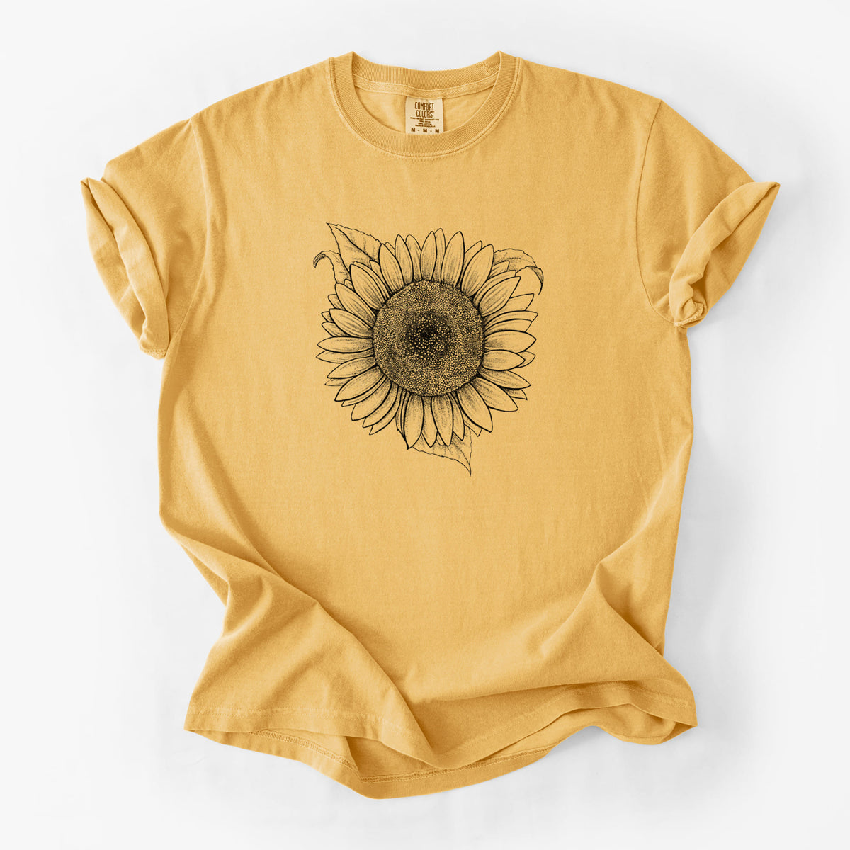 Golden wheat yellow Comfort Colors t-shirt laid flat, printed with a detailed black ink line drawing of a Lemon Queen sunflower in bloom.