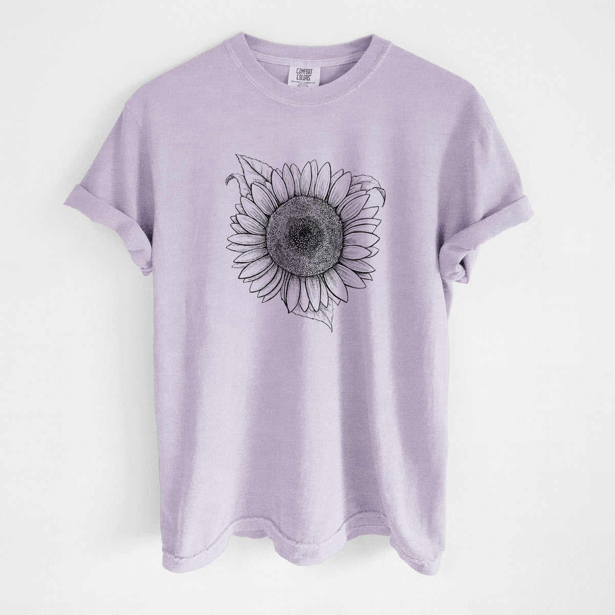 Orchid purple Comfort Colors t-shirt laid flat, printed with a detailed black ink line drawing of a Lemon Queen sunflower in bloom.