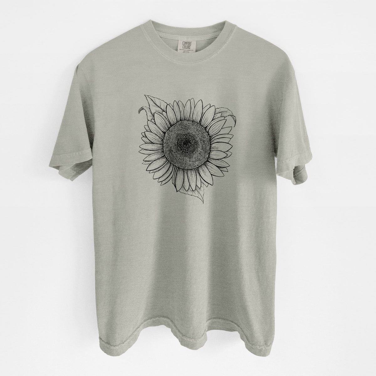 Sandstone beige Comfort Colors t-shirt laid flat, printed with a detailed black ink line drawing of a Lemon Queen sunflower in bloom.
