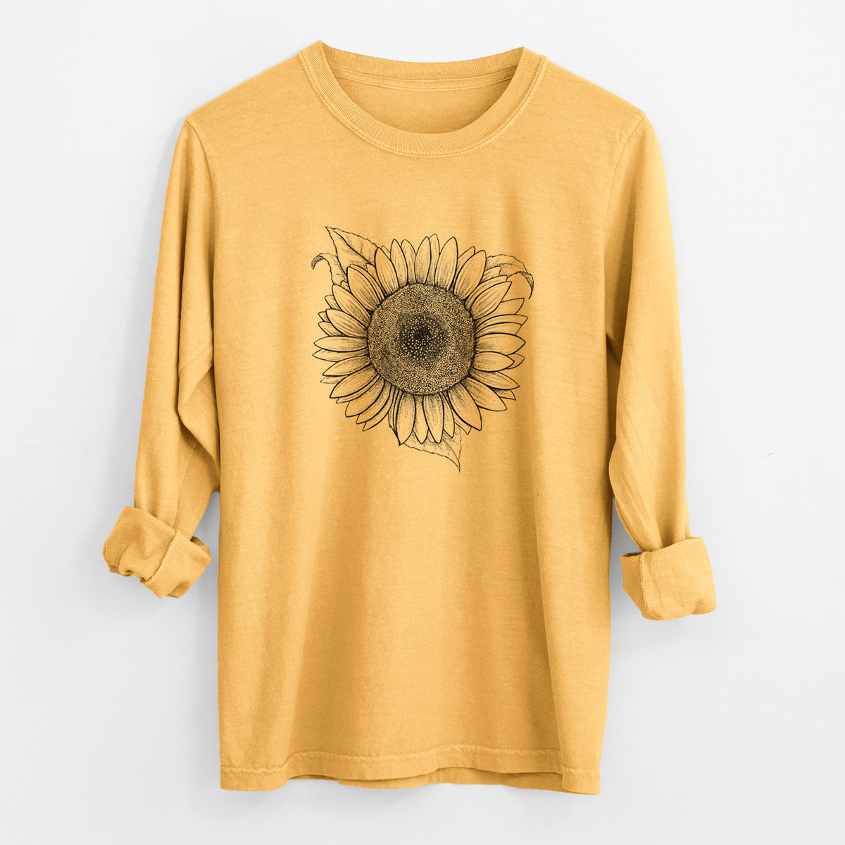 Golden wheat yellow Comfort Colors long sleeve shirt laid flat with the cuffs rolled, printed with a detailed black ink line drawing of a Lemon Queen sunflower in bloom.