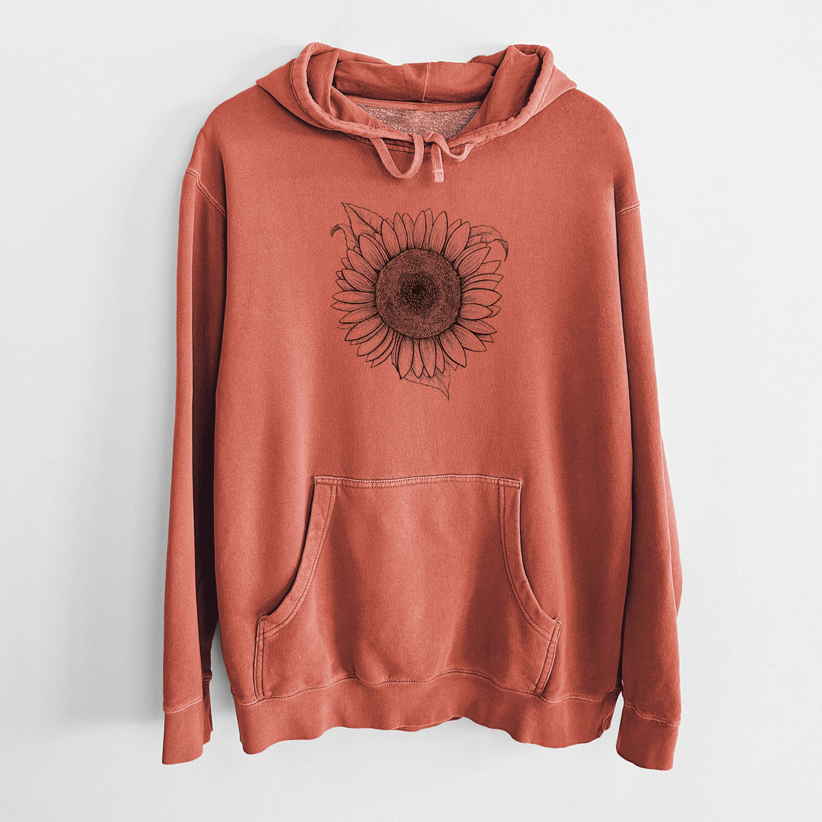 Amber orange pigment dyed hoodie laid flat, printed with a detailed black ink line drawing of a Lemon Queen sunflower in bloom.