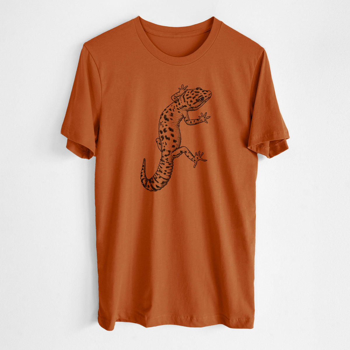 Autumn lightweight cotton t-shirt laid flat, printed with a detailed black ink illustration of a spotted leopard gecko climbing.