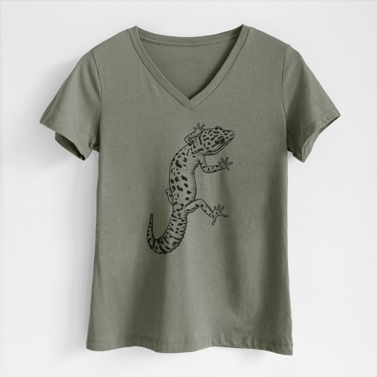 Military green women's relaxed fit cotton V-neck t-shirt laid flat, printed with a detailed black ink illustration of a spotted leopard gecko climbing.