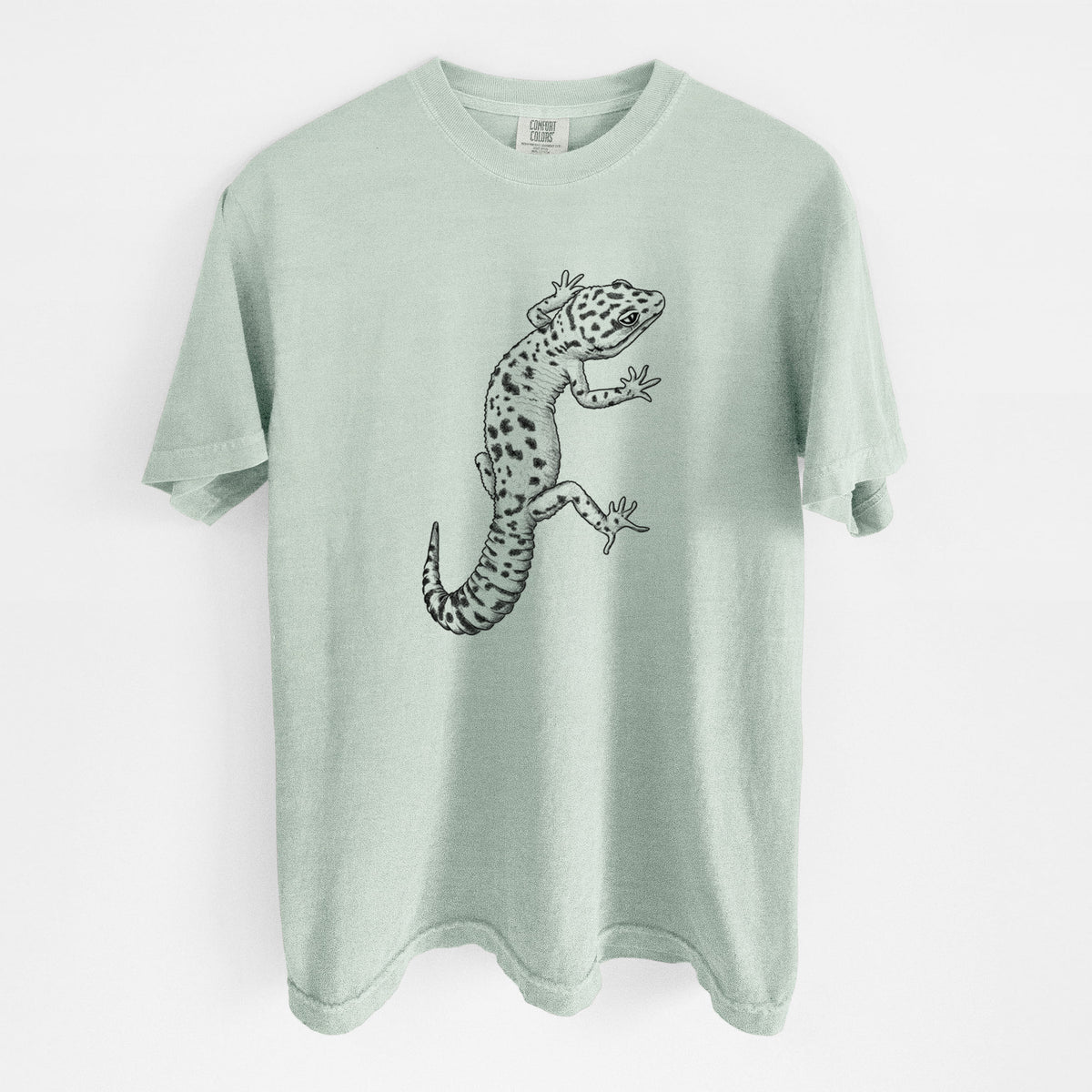 Bay green Comfort Colors t-shirt laid flat, printed with a detailed black ink illustration of a spotted leopard gecko climbing.
