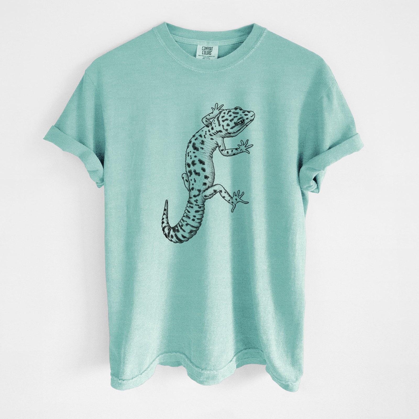Blue jean Comfort Colors t-shirt laid flat, printed with a detailed black ink illustration of a spotted leopard gecko climbing.
