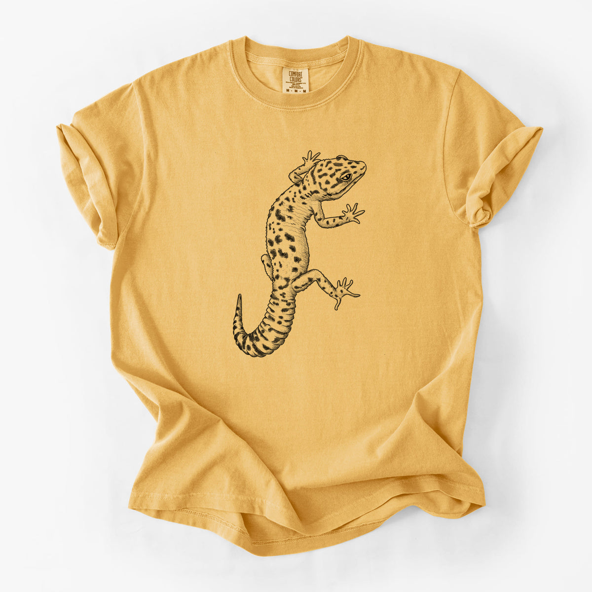 Golden wheat yellow Comfort Colors t-shirt laid flat, printed with a detailed black ink illustration of a spotted leopard gecko climbing.