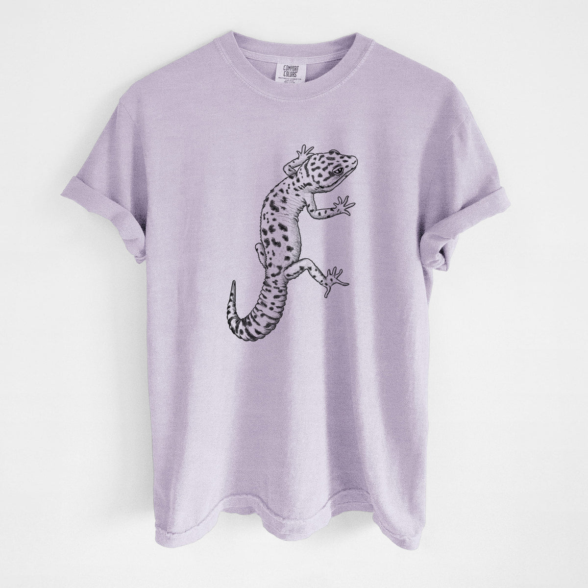 Orchid purple Comfort Colors t-shirt laid flat, printed with a detailed black ink illustration of a spotted leopard gecko climbing.