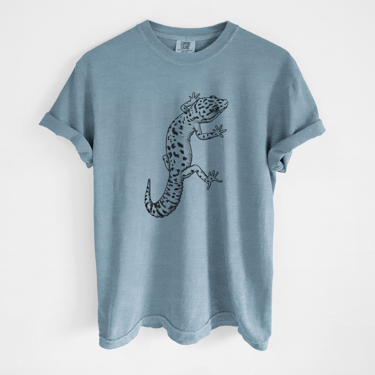 Steel blue Comfort Colors t-shirt laid flat, printed with a detailed black ink illustration of a spotted leopard gecko climbing.