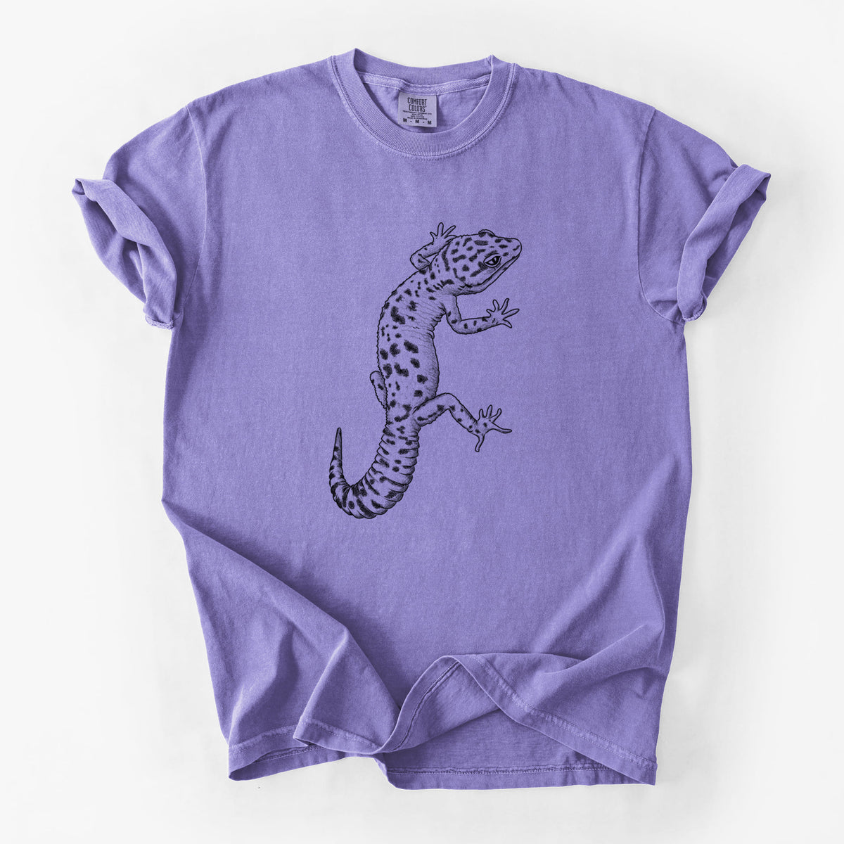 Violet purple Comfort Colors t-shirt laid flat, printed with a detailed black ink illustration of a spotted leopard gecko climbing.