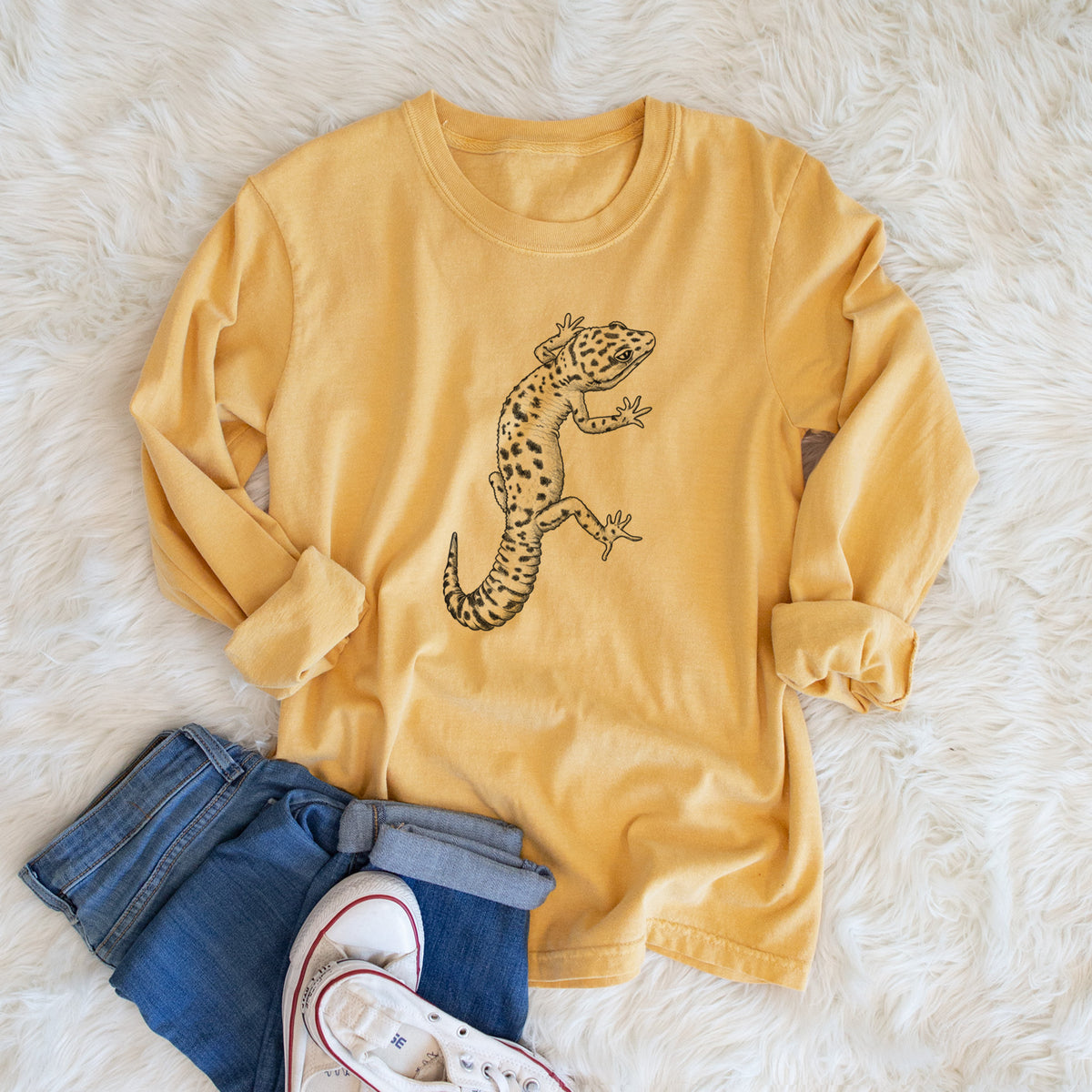 Golden wheat yellow Comfort Colors long sleeve shirt printed with a detailed black ink illustration of a spotted leopard gecko climbing, shown in a lifestyle photo.