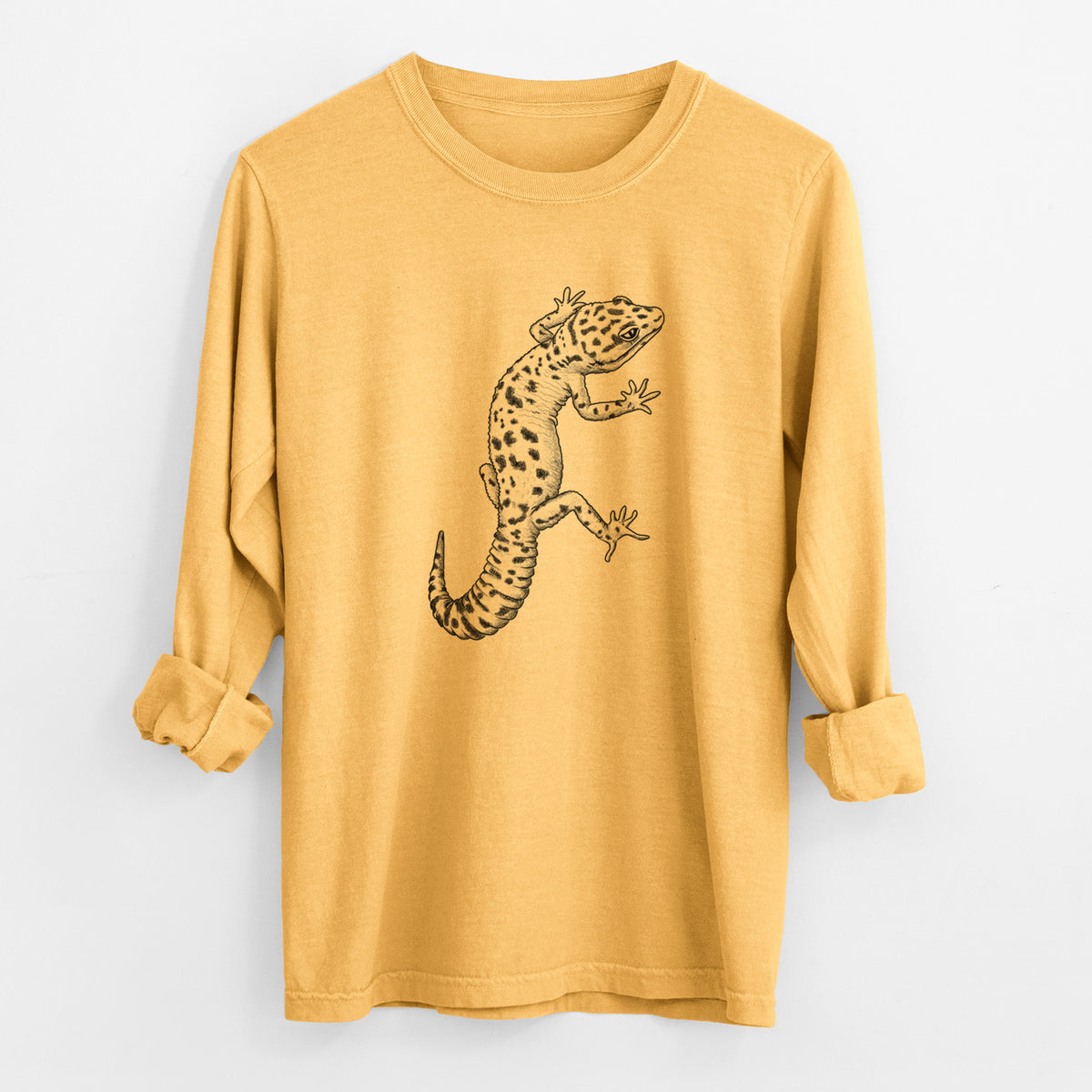 Golden wheat yellow Comfort Colors long sleeve shirt laid flat with the cuffs rolled, printed with a detailed black ink illustration of a spotted leopard gecko climbing.