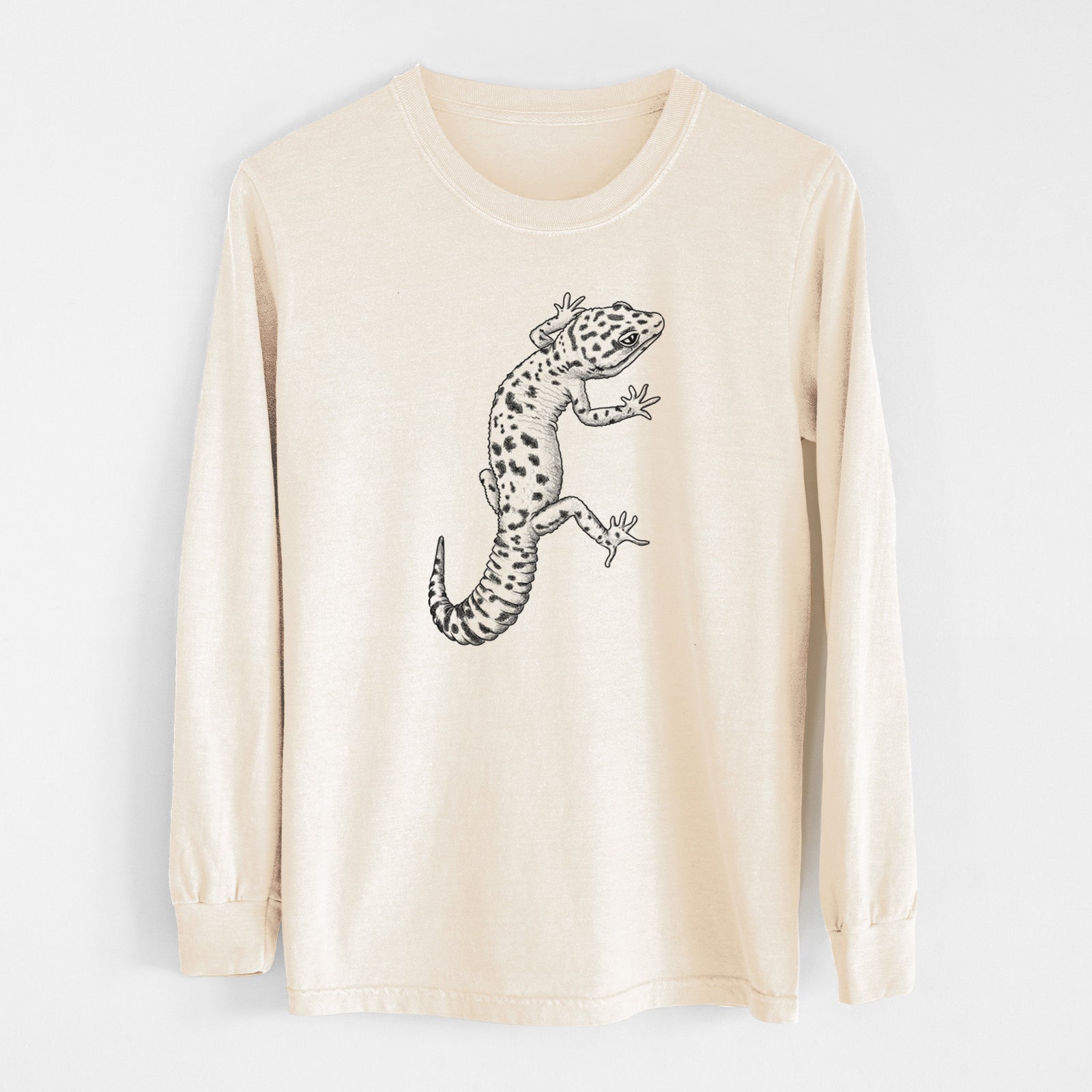 Ivory Comfort Colors long sleeve shirt laid flat, printed with a detailed black ink illustration of a spotted leopard gecko climbing.
