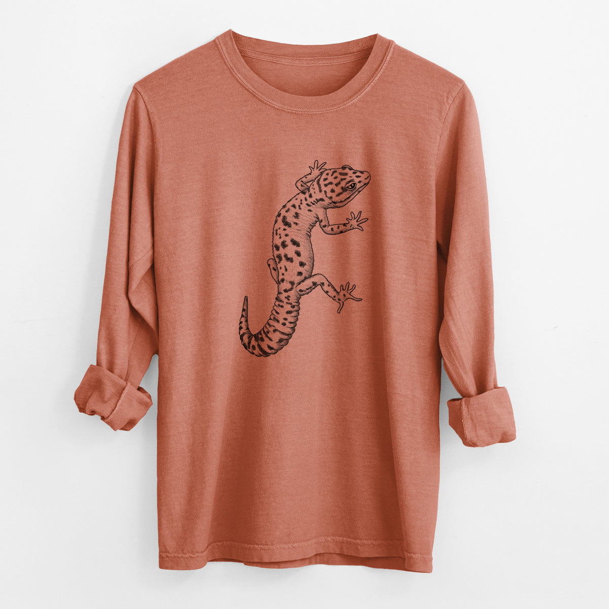 Yam burnt orange Comfort Colors long sleeve shirt laid flat with the cuffs rolled, printed with a detailed black ink illustration of a spotted leopard gecko climbing.
