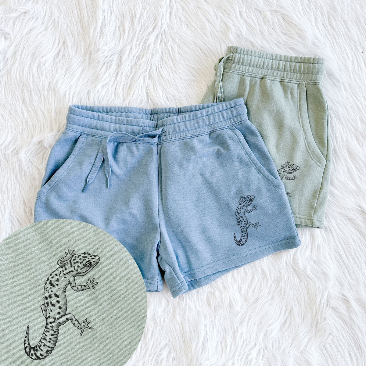 Two pairs of Cali Wave shorts in different colors printed with a detailed black ink illustration of a spotted leopard gecko climbing, with a close-up of the print.
