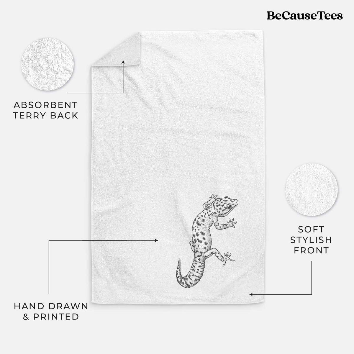 White hand towel printed with a detailed black ink illustration of a spotted leopard gecko climbing.