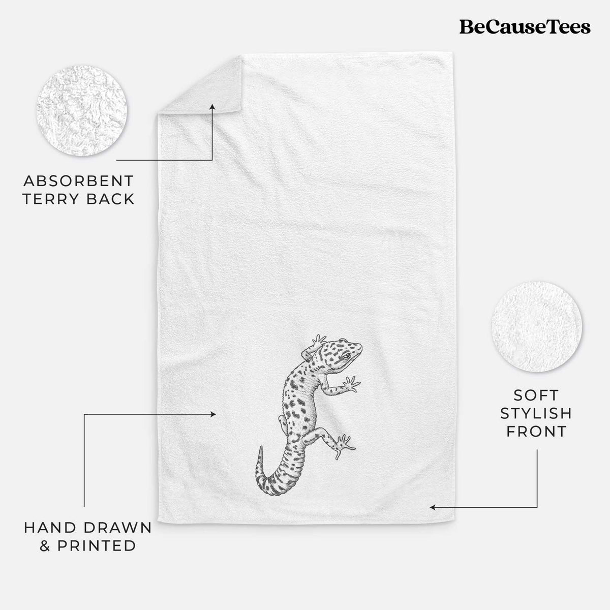 White hand towel printed with a detailed black ink illustration of a spotted leopard gecko climbing.