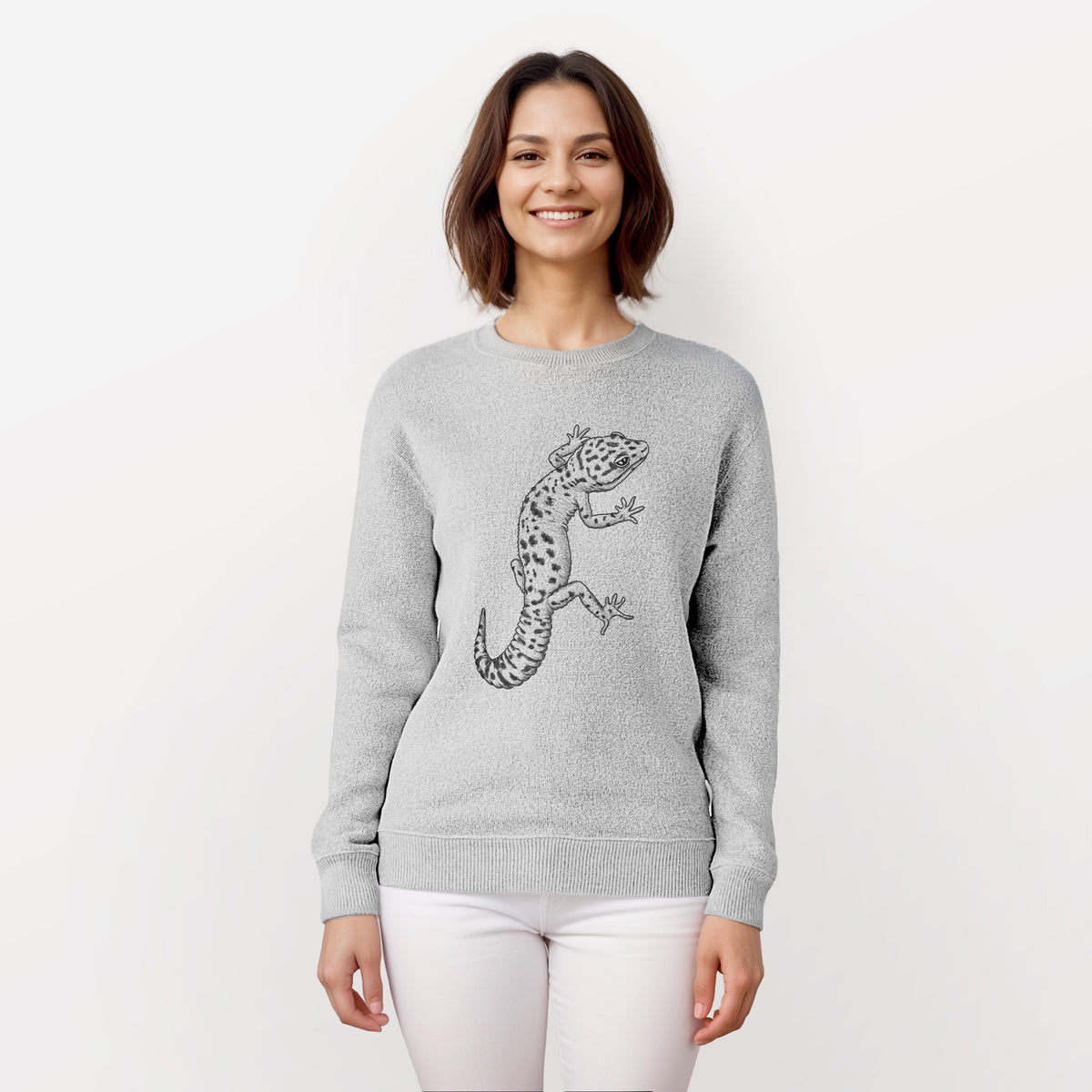 Woman wearing a knit sweatshirt printed with a detailed black ink illustration of a spotted leopard gecko climbing.