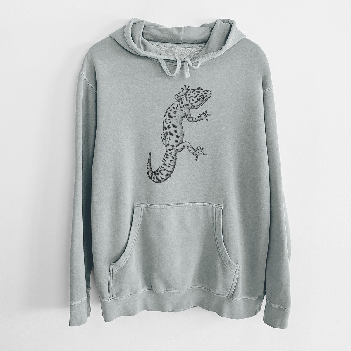 Sage green pigment dyed hoodie laid flat, printed with a detailed black ink illustration of a spotted leopard gecko climbing.