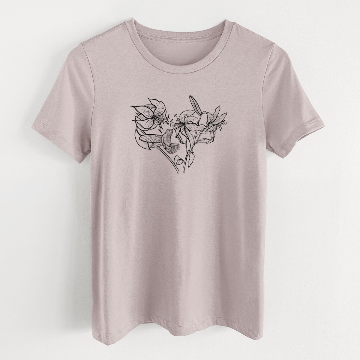Pink gravel women's relaxed fit cotton t-shirt laid flat, printed with a black ink line drawing of lilies and a hummingbird arranged in a heart shape.