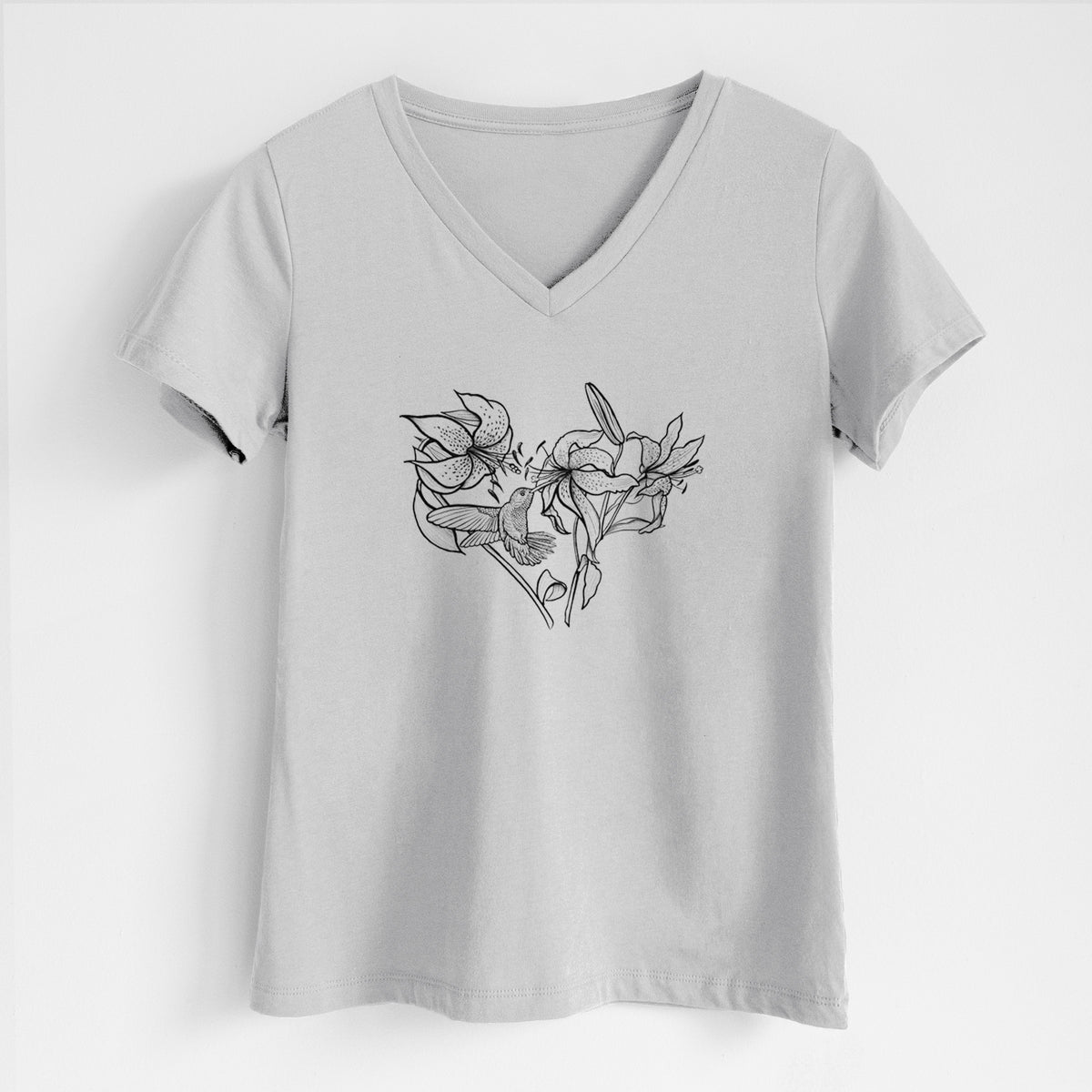 Lunar grey women's relaxed fit cotton V-neck t-shirt laid flat, printed with a black ink line drawing of lilies and a hummingbird arranged in a heart shape.