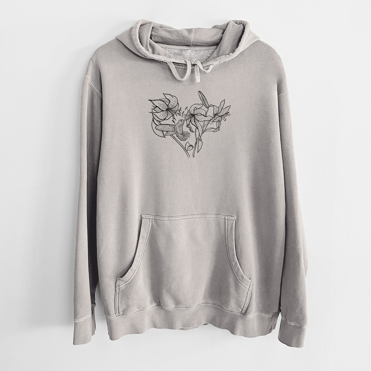 Cement grey pigment dyed hoodie laid flat, printed with a black ink line drawing of lilies and a hummingbird arranged in a heart shape.