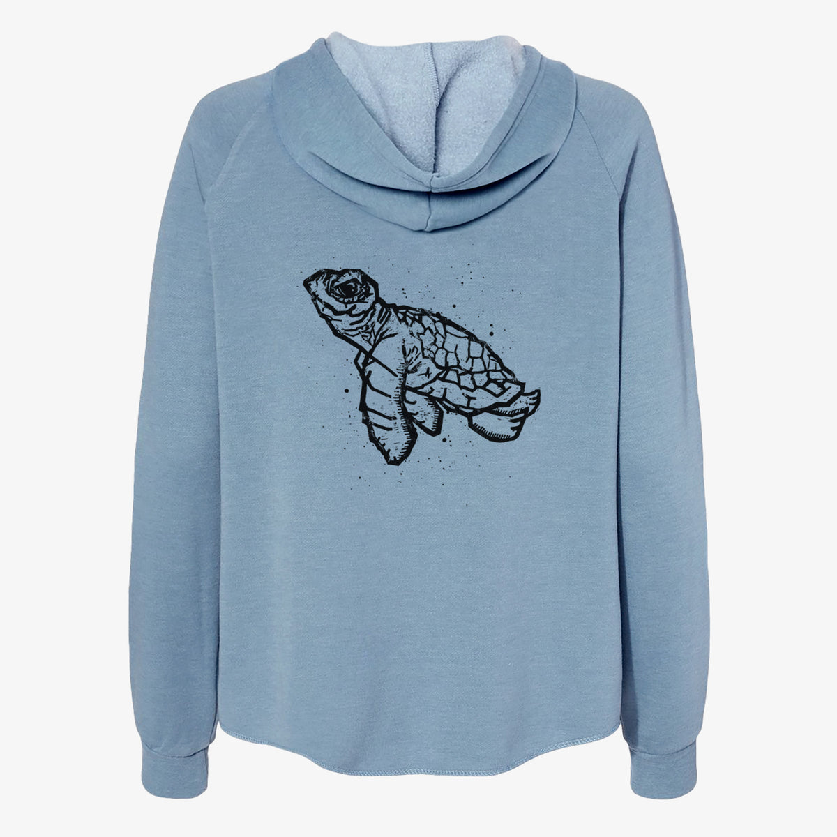 Misty blue women's Cali Wave zip-up sweatshirt laid flat, printed with a black linocut-style illustration of a baby sea turtle with a patterned shell and ink splatters.
