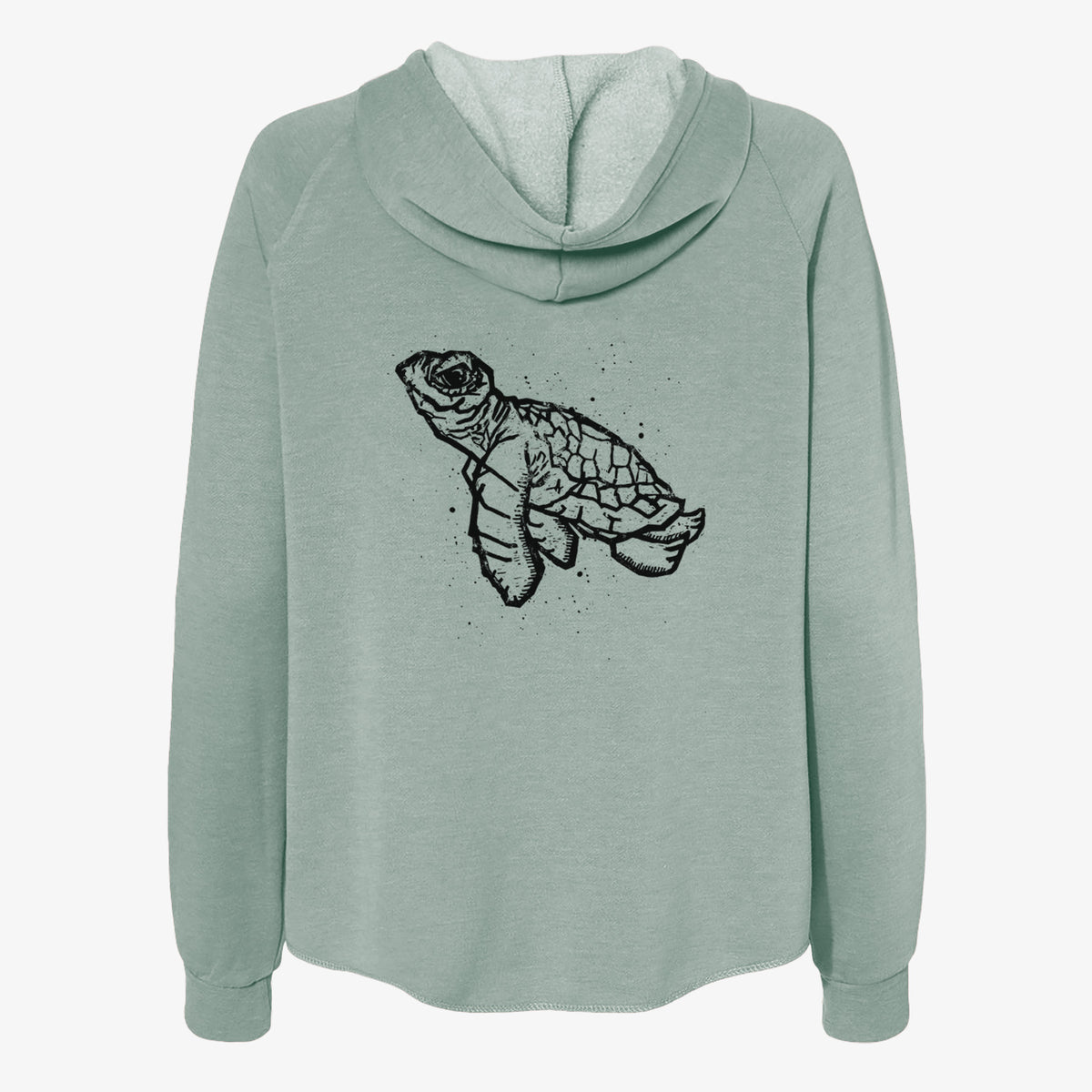 Sage green women's Cali Wave zip-up sweatshirt laid flat, printed with a black linocut-style illustration of a baby sea turtle with a patterned shell and ink splatters.
